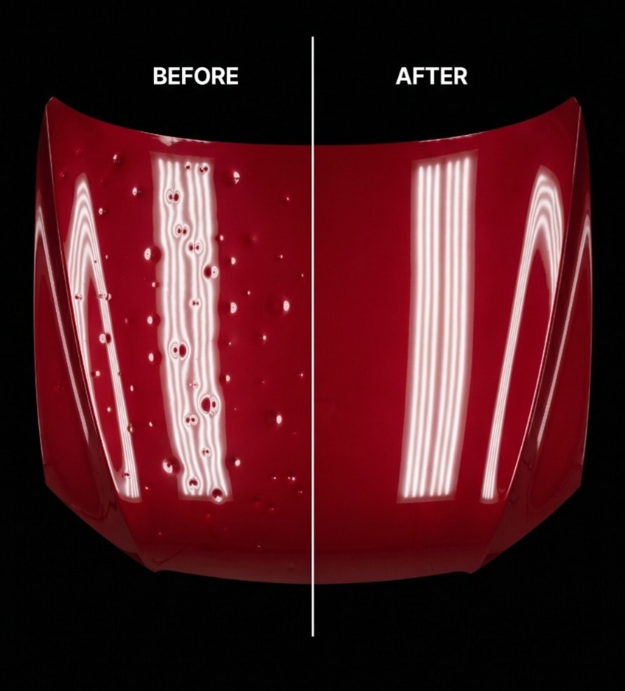 PDR technician using professional lighting to reveal and repair hail dents on a vehicle panel